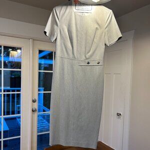 A sleek light grey Calvin Klein work dress featuring silver buttons.